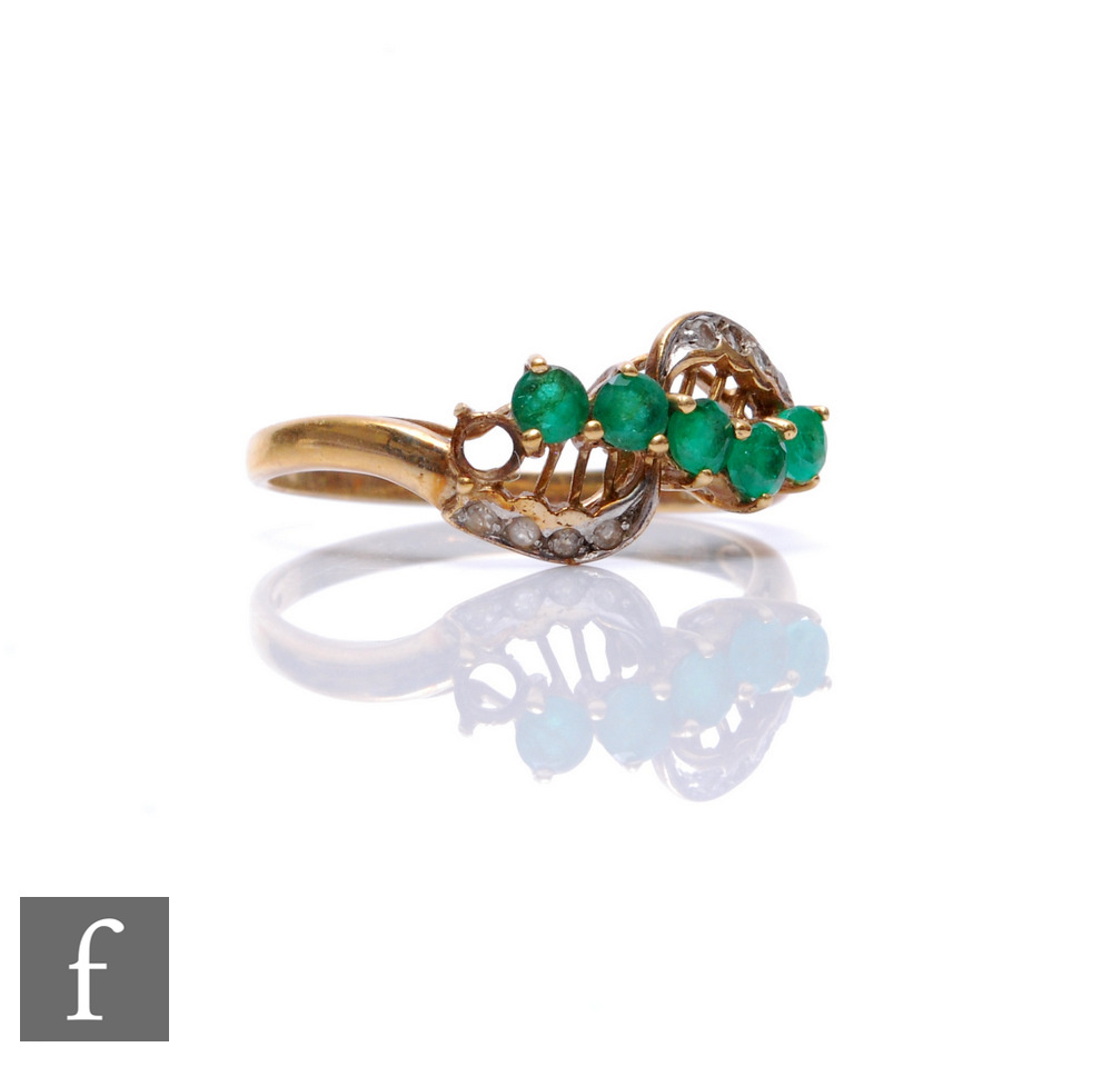 A 9ct hallmarked emerald and diamond ring, five emeralds and eight diamonds to a slight twist,