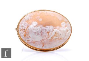 A 9ct mounted oval cameo brooch depicting two classical ladies in a garden setting, weight 22g,