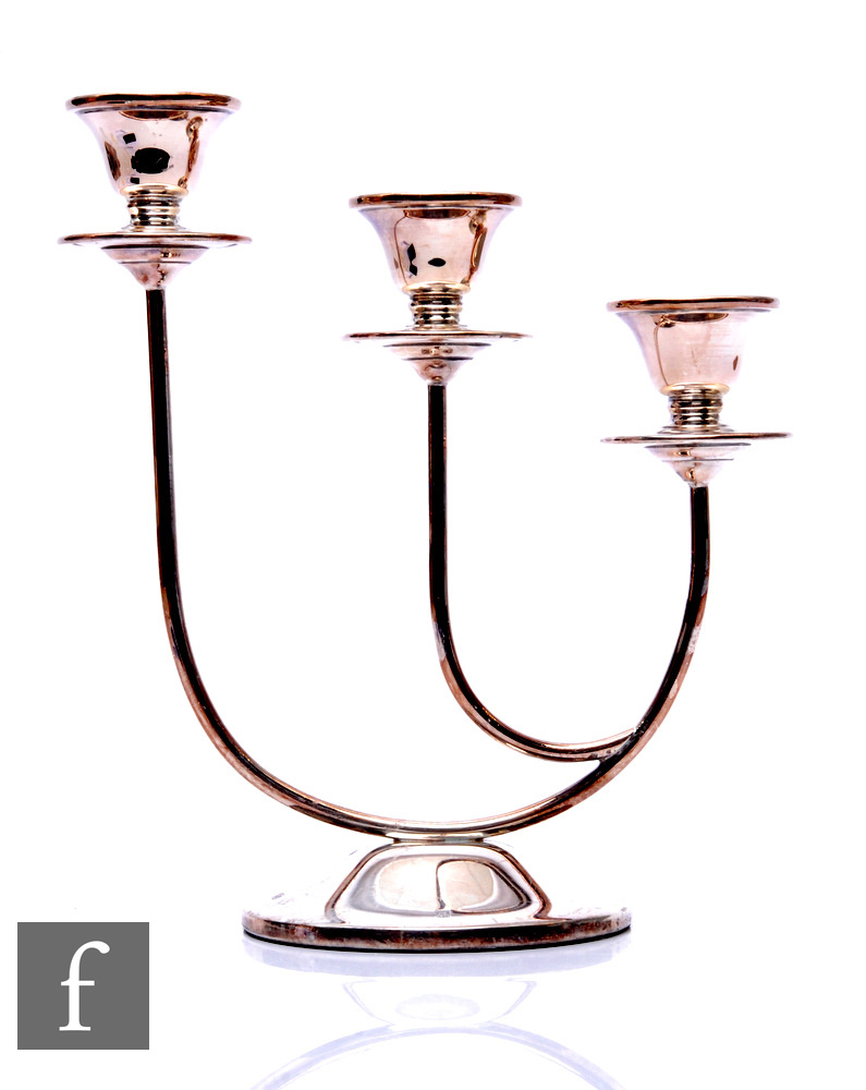 A modern hallmarked silver three light candelabra, circular base below stepped circular sconces,