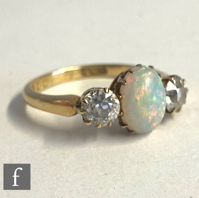 An 18ct opal and diamond three stone ring, central oval opal, length 9mm, flanked by a 0.40ct - Image 5 of 5