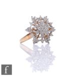 A 9ct hallmarked diamond cluster ring modelled as a snowflake with pierced details, weight 4.5g,