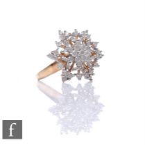 A 9ct hallmarked diamond cluster ring modelled as a snowflake with pierced details, weight 4.5g,