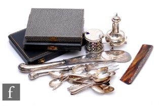 A small parcel lot of hallmarked silver items to include mustard and pepper pots, fish servers and