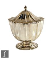 A hallmarked silver pedestal tea caddy with fluted decoration above on oval foot, weight 6oz, height