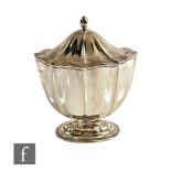 A hallmarked silver pedestal tea caddy with fluted decoration above on oval foot, weight 6oz, height