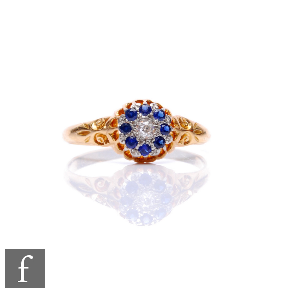 An early 20th Century 18ct sapphire and diamond cluster ring, central old diamond within a border of