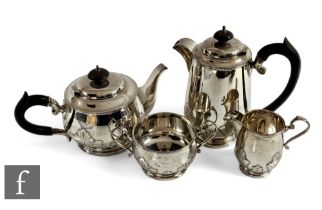 A hallmarked silver four piece tea set decorated with part relief floral frieze to base, total