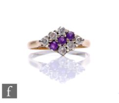 A 9ct hallmarked amethyst and diamond cluster ring, three central amethysts flanked by three