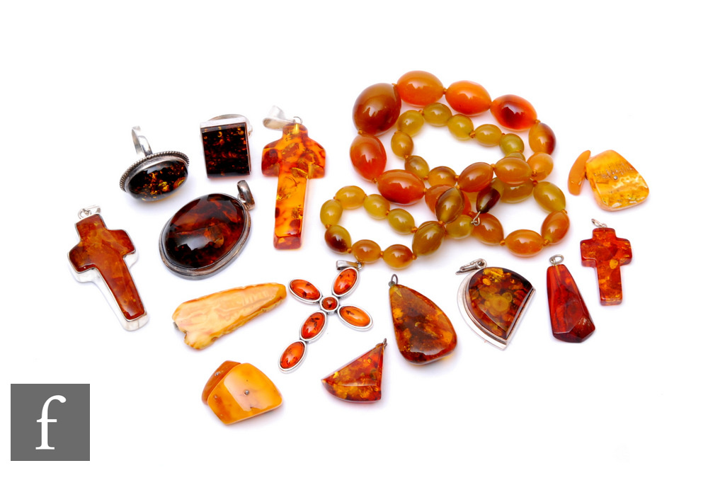 A small parcel lot of assorted Baltic amber to include pendants, rings etc, with a row of similar