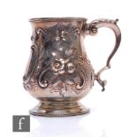 A Victorian hallmarked silver baluster tankard with foliate engraved and embossed decoration to