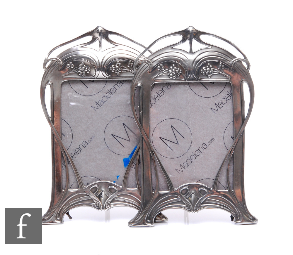 A pair of WMF polished pewter shaped rectangular easel photograph frames, each with whiplash and