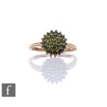 A 9ct hallmarked green diamond cluster ring, three tier stepped cluster to knife edged shoulders,