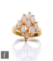An 18ct opal cluster ring comprising nine marquise claw set stones, weight 3.5g, ring size M.
