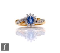 An 18ct sapphire and diamond cluster ring, central sapphire within a border of diamonds and