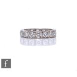 An 18ct hallmarked white gold, diamond full eternity ring comprising sixteen brilliant cut stones,