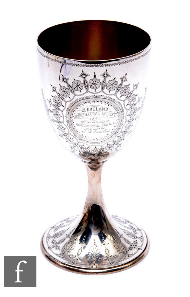 A hallmarked silver trophy goblet engraved with floral details and presentation script, weight 12oz,