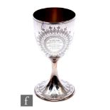 A hallmarked silver trophy goblet engraved with floral details and presentation script, weight 12oz,