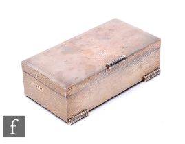 An Art Deco style hallmarked silver rectangular cigarette box with engine turned decoration raised