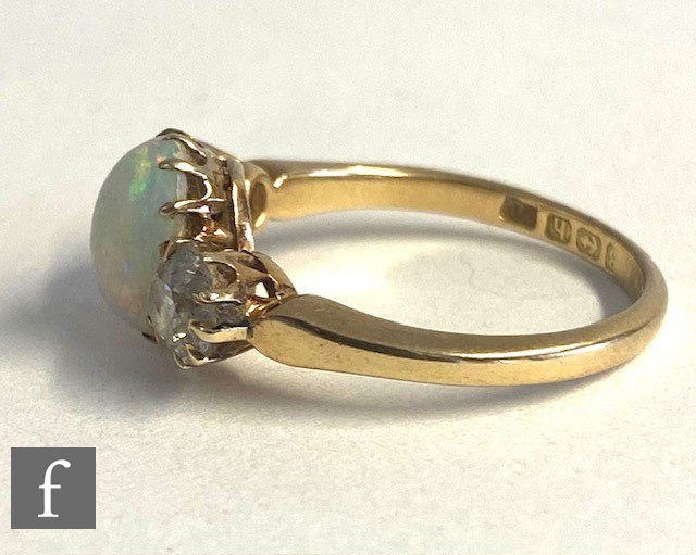 An 18ct opal and diamond three stone ring, central oval opal, length 9mm, flanked by a 0.40ct - Image 4 of 5
