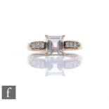 A 9ct hallmarked green amethyst and diamond ring, central square cut amethyst flanked by diamond set
