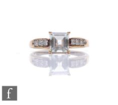 A 9ct hallmarked green amethyst and diamond ring, central square cut amethyst flanked by diamond set