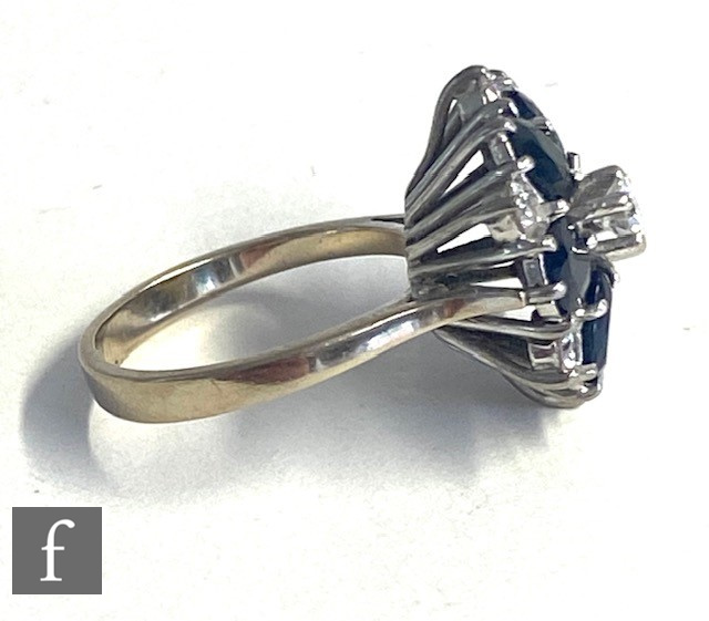 An 18ct white gold sapphire and diamond cluster ring, central diamond with six oval radiating - Image 5 of 6