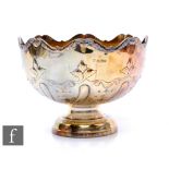 A hallmarked silver pedestal bowl with part foliate embossed decoration and gilt interior, weight