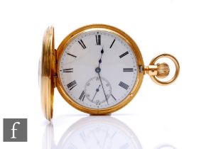 An 18ct hallmarked, crown wind, half hunter pocket watch, Roman numerals to a white enamelled