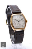 A 1940s 14ct Longines manual wind wrist watch, open Arabic numerals to a cushioned rectangular dial,