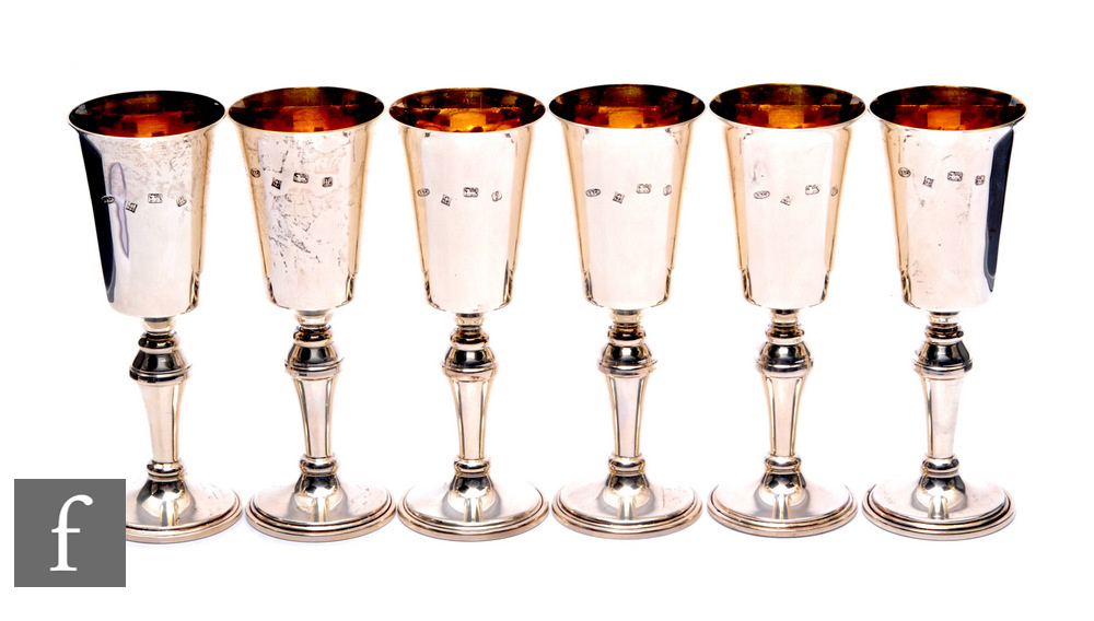 A set of six hallmarked silver pedestal goblets, circular base, knop stem and tulip bowl, gilded