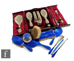 An Edwardian hallmarked silver dressing table set comprising four brushes, hand mirror, button hook,