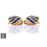 A pair of 18ct sapphire and diamond stud earrings each comprising three rows of baguette sapphires