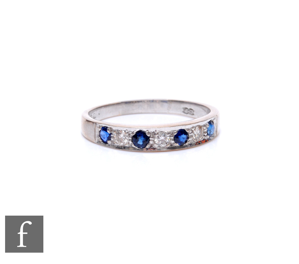 An 18ct hallmarked white gold sapphire and diamond seven stone half eternity ring, weight 3.9g, ring