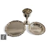 Three items of modern hallmarked silver, a card waiter, a bottle coaster and a goblet, total
