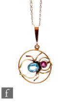 An Edwardian 9ct circular pendant with central spider set with aquamarine and pink tourmaline