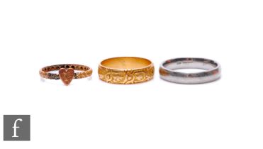 A 18ct hallmarked pattern wedding ring, Chester 1884, weight 4g, a platinum wedding ring, weight 4.