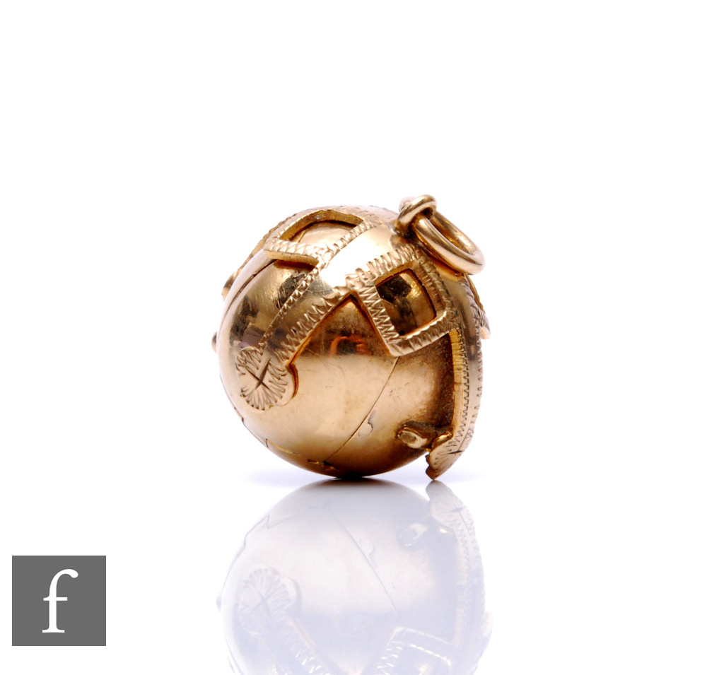 A 1960s gold on silver Masonic ball with 9ct mount, length 5cm when open.