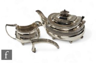 A hallmarked silver boat shaped teapot and a matched cream jug, total weight 25oz, London 1814 and