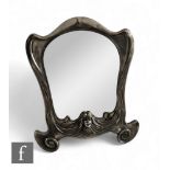 An Art Nouveau Orivit polished pewter easel mirror with a central portrait of a maiden to lower