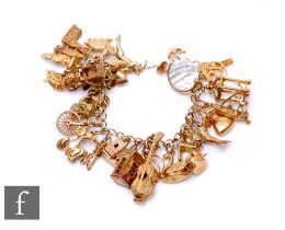 A 9ct open curb link charm bracelet with various charms attached, total weight 70g, terminating in
