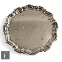 A hallmarked silver circular salver with central presentation engraving within stepped borders and