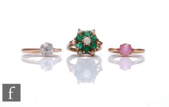 Three assorted 9ct stone set rings to include an emerald and opal cluster and two paste single
