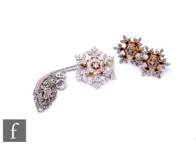 A pair of 9ct hallmarked diamond stud earrings each modelled as a snowflake, with a matching pendant