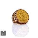 A 9ct hallmarked full sovereign ring, loose mounted coin dated 1909, to a pierced shank, total