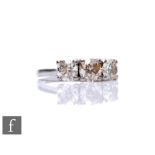 An 18ct white gold diamond three stone ring, brilliant cut claw set stones, central stone 1.00ct,