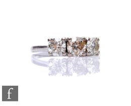 An 18ct white gold diamond three stone ring, brilliant cut claw set stones, central stone 1.00ct,