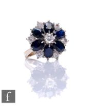 An 18ct white gold sapphire and diamond cluster ring, central diamond with six oval radiating