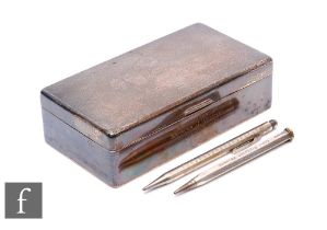 A hallmarked silver rectangular cigarette box with engine turned decoration to hinged lid, length