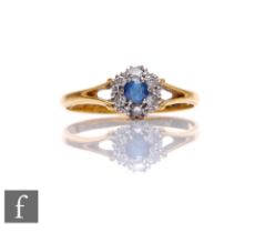 A mid 20th Century sapphire and diamond cluster ring, central sapphire within a border of six