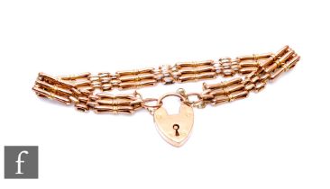 A 9ct rose gold three bar gate bracelet, weight 10g, terminating in a padlock fastener.